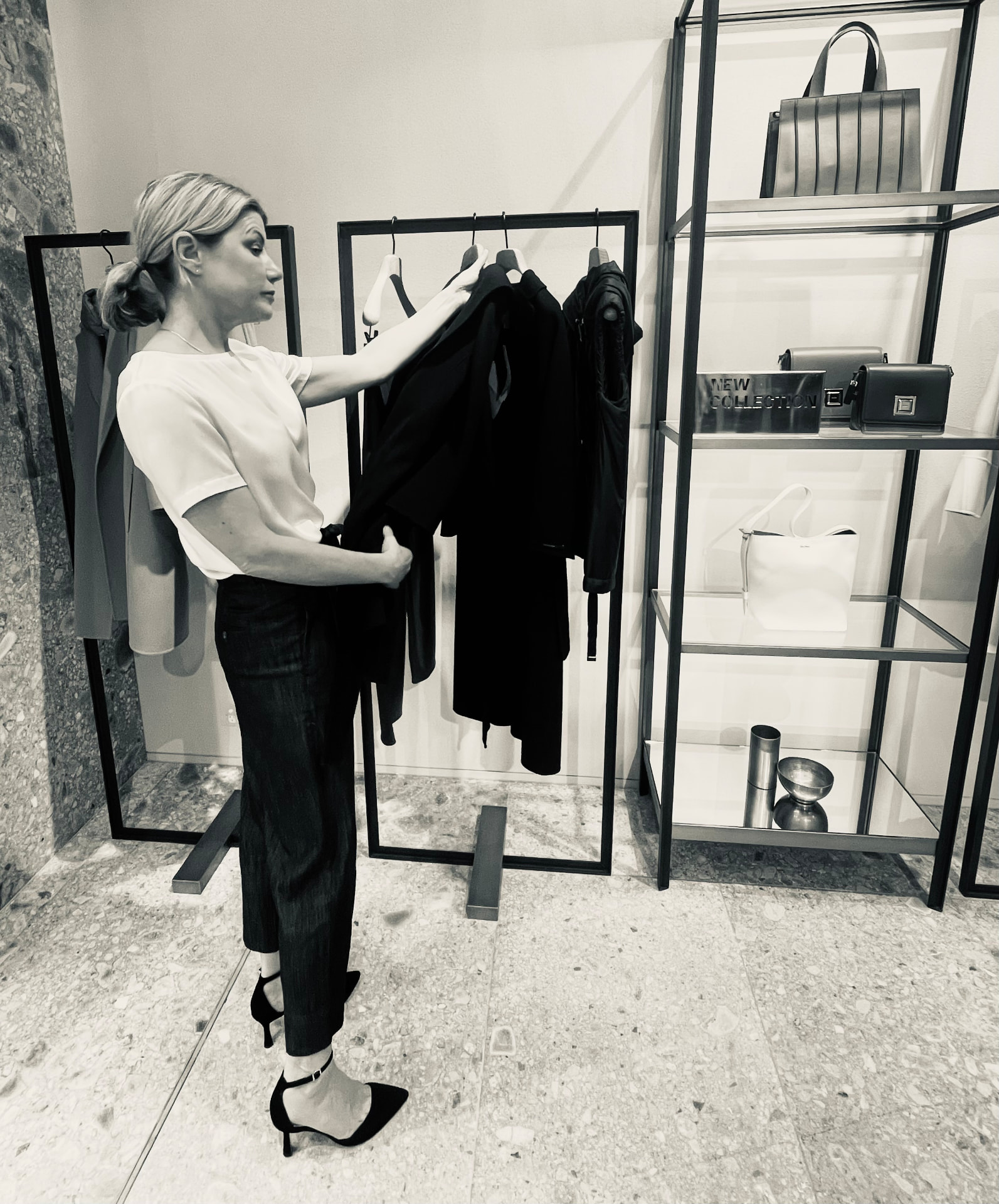 Shareen Beringer selecting garments in a curated wardrobe space